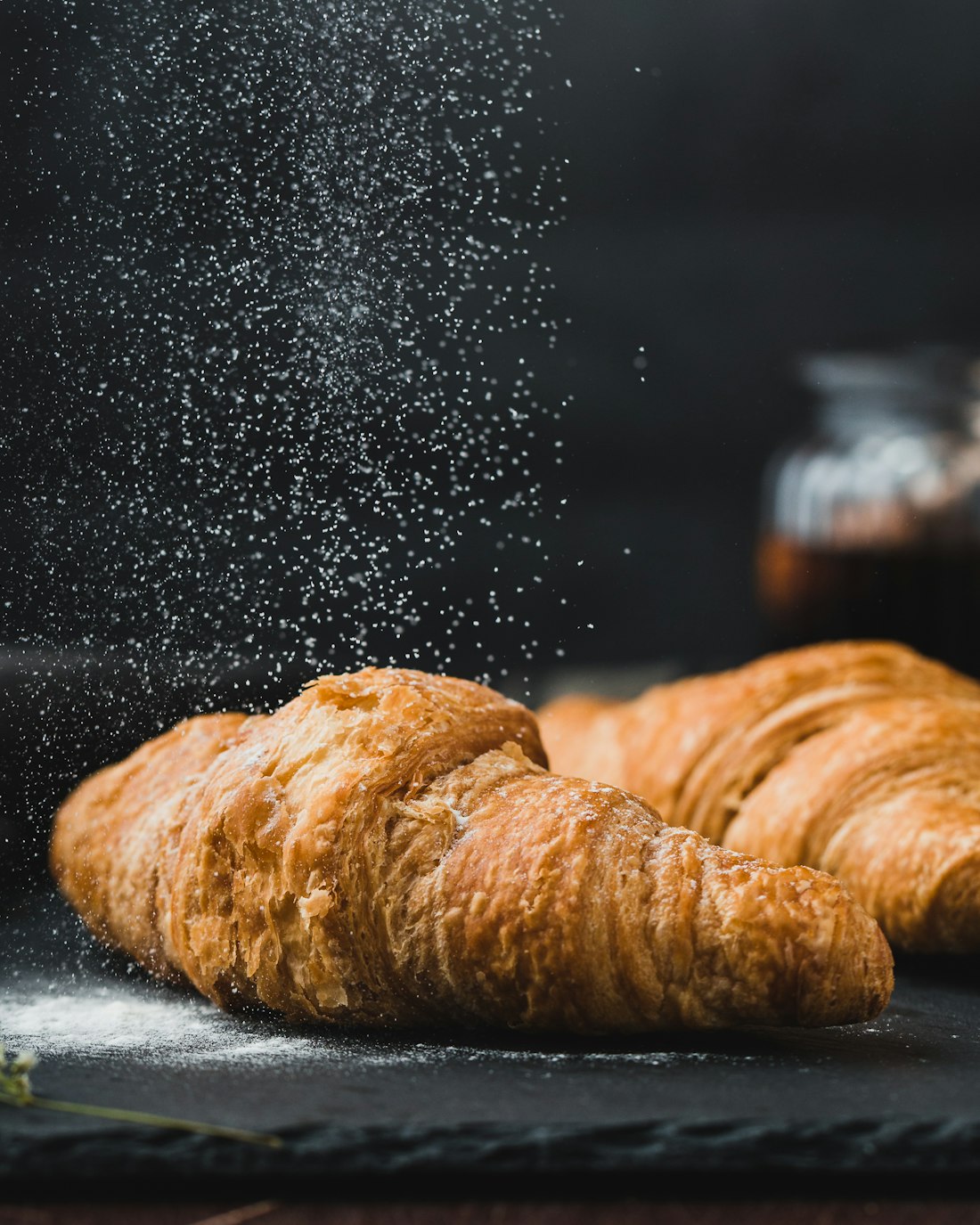 Freshly baked golden croissants and pastries, still warm from the oven