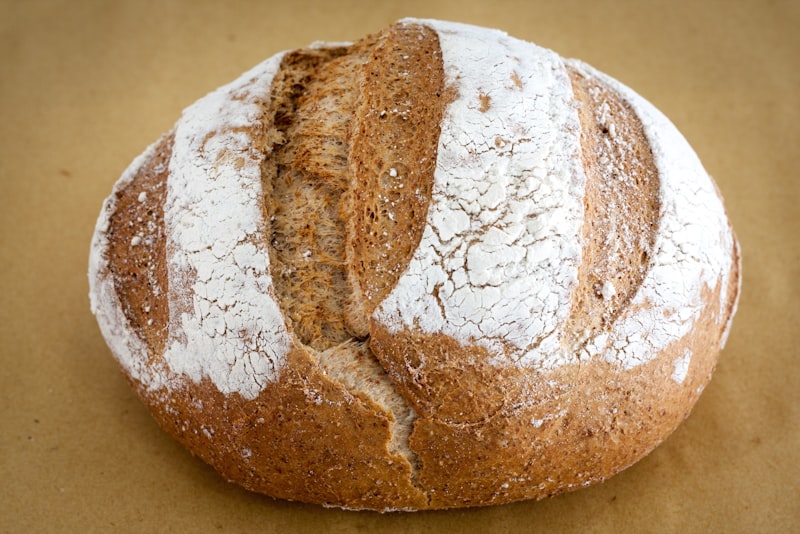 Two rustic loaves cooling on a rack