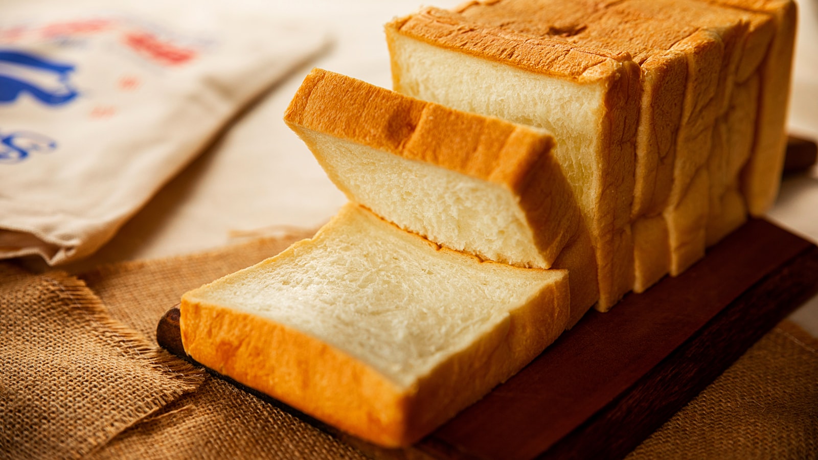Hands kneading dough on a floured surface